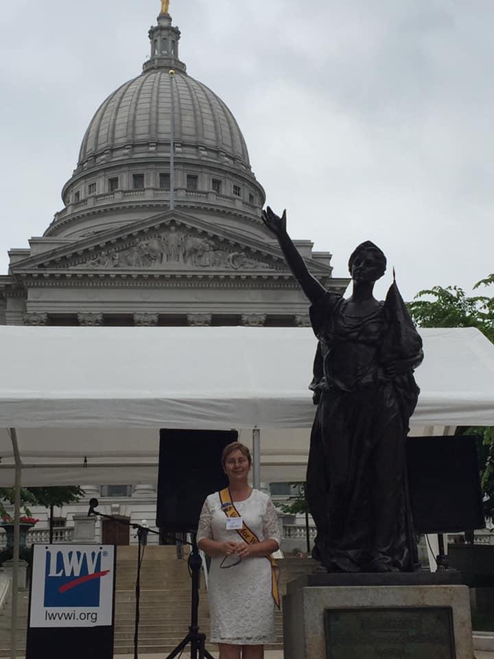 LWVWI Board Member Joy Cardin next to the Forward statue