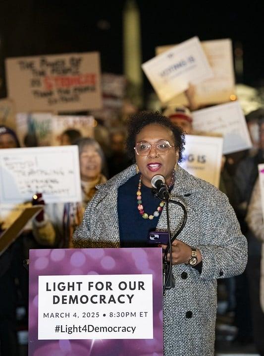 CEO Celina Stewart speaking at the Light for Our Democracy rally in March 2025