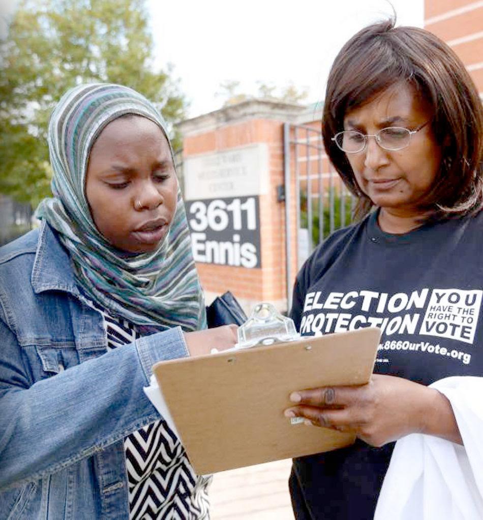 Two women looking at a clip board