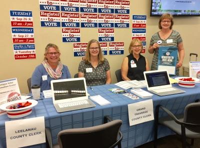 League members pose for a photo at registration table on National Voter Registration Day