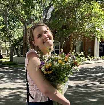 Smiling girl holding flowers