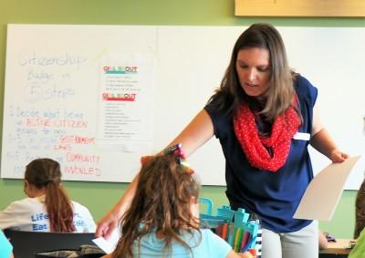 teacher in blue top and red neck scarf