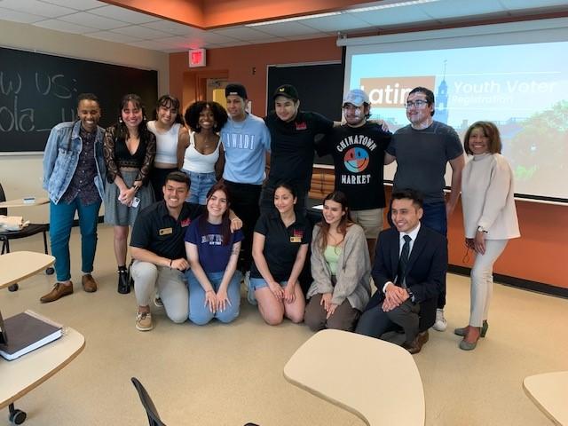 A diverse group of students and adults poses at "Be Their Voice" Latino Youth Voter Registration event