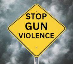 Stop Gun Violence road sign with a cloudy background