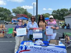 Photo of Sussex LWV members at Impact festival table