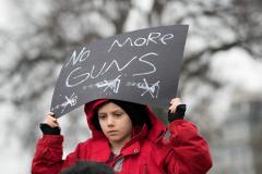 Girl holding No more guns poster
