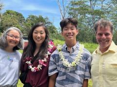 2024 LWVHC Hawai'i History Day award winner Cole Aragaki and his mom, Whitney Aragaki (center, with leis), with HHD Hawai'i Island consultant Micheal Bitter, and LWVHC Co-President Michele Mitsumori