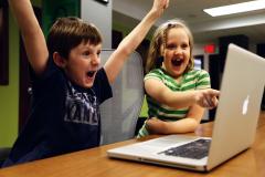 Kids excited at a laptop