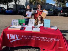 Three women at LWV table with red table cloth