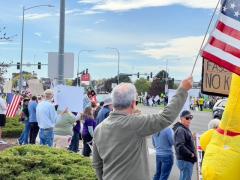 People holding American flags at a protest.