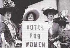 3 women from 1900s  holding sign saying Votes for Women