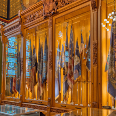picture of the righthand side wall of cases in the Hall of Flags at the CT State Capitol
