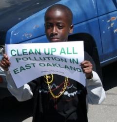 Black youth holding sign against pollution