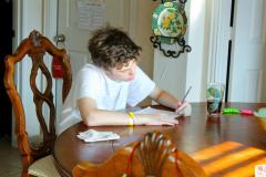 teenager doing homework at table