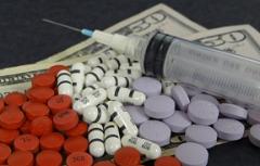 pills, syringe, $50 bills