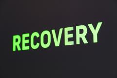 the word "Recovery" in large glowing green letters on black