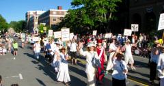 picture by Jeannette Wuff of members in white suffragette costumes in the July 4th parade in Montpelier 2018