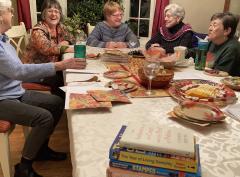 Stack of books with women at a table