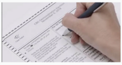election ballot with hand marking the ballot with a pen