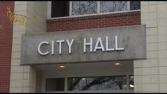 Photo of sign on building that reads City Hall