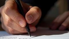 closeup of hand signing with a pen