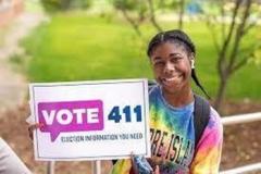 Young lady holding a Vote411 sign