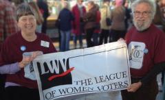 Photo of Becky and Riley Newman with LWV Banner