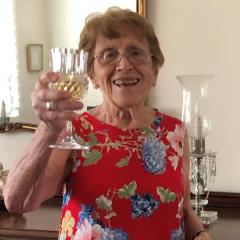 Photo of Jennie Silva with glass up to toast to the photographer