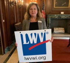 Debra Cronmiller with a LWV sign