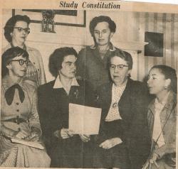 Image of group of women holding a document with the caption of Study Constitution