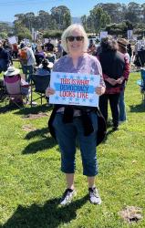 Rally participant with a sign saying "This is what democracy looks like"