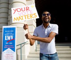 Man Holding Your Vote Matters Sign Credit LWVUS