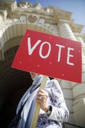 Woman Holding Red VOTE Sign Credit LWVUS