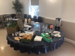 round table is shown with breakfast spread of bagels and beverages