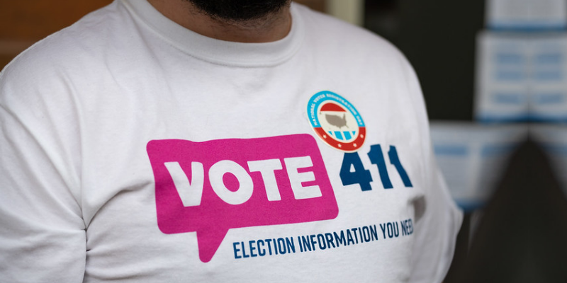 Photo of a VOTE 411 T-shirt with a National Voter Registration Day sticker