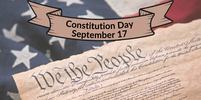 photo of the american flag with a partial page of the U.S. Constitution.  A banner reads Constitution Day September 17