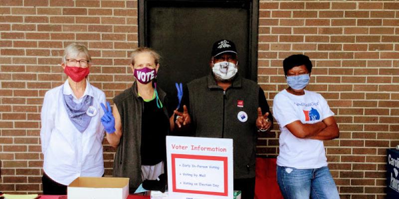 League members and I Vote Too Campaign at a voter education table