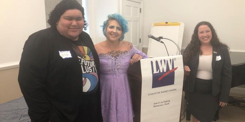 Our three keynote speakers are shown next to the podium with LWV banner