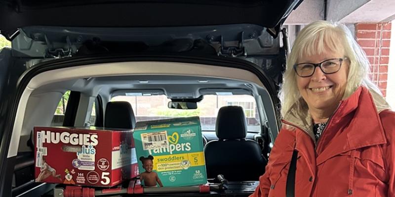 Jill with carload of diapers donated to Centro Hispano at 2024 annual meeting