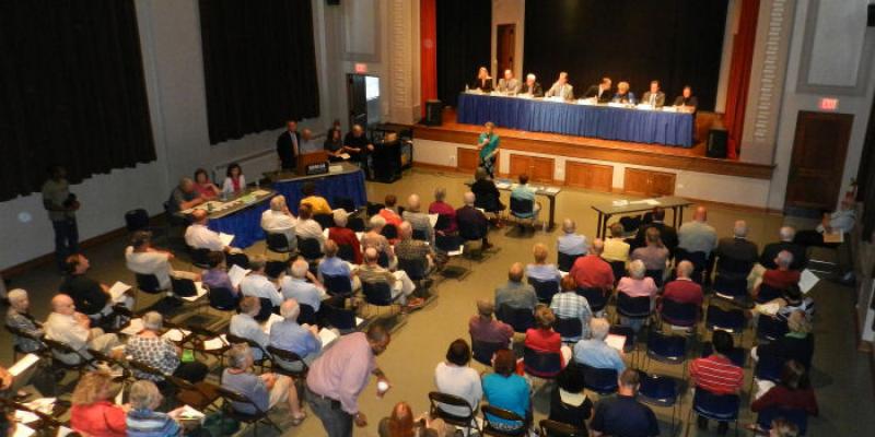 Candidate forum, Sept 21, 2012 Image looking down on an theater filled with people in the audience, and a line of candidates sitting on the stage