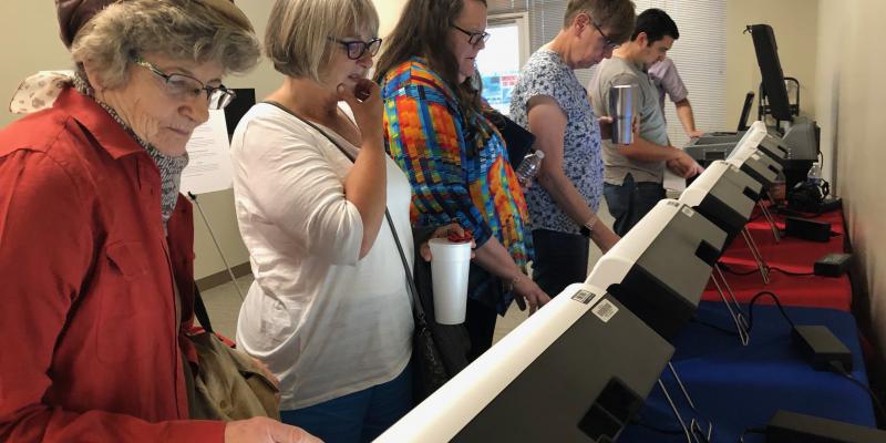 Hays County voters try out ES&S's Express Vote ballot marking device photo of voters trying new voting machines