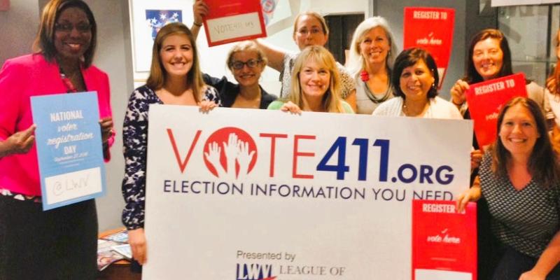 vote 411 sign with women