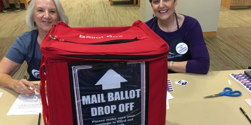 LWVNCSD participates in mail ballot dropoff Two League members manning the mail ballot drop off