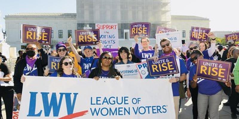 people rally on the steps of the Supreme Court, LWV, Unite & Rise signs
