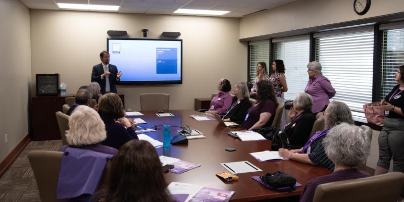 Meeting room shown with League of Women Voters members and guests along with state representatives