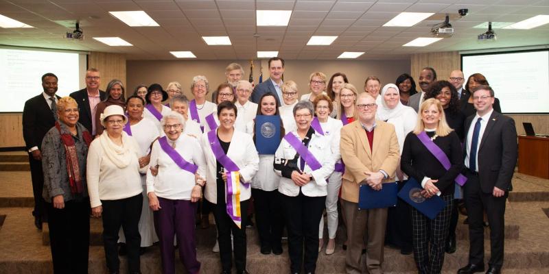 League Honored by Local Governements Group photo of League members and local oficials