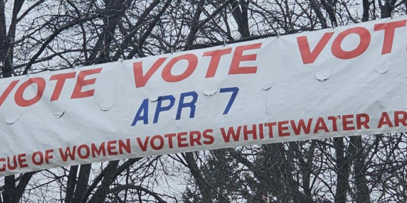 Street banner reading "VOTE VOTE VOTE Apr 7"