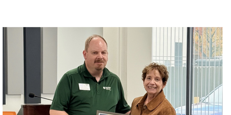 Photo of 2 people with award certificate