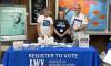 Members register students on a college campus