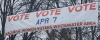 Street banner reading "VOTE VOTE VOTE Apr 7"